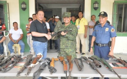 <p><strong>FIREARMS YIELD.</strong> Mayor Abubacar Paglas of Datu Paglas, Maguindanao leads the turnover of loose firearms to Army's 33rd Infantry Battalion commander Harold Cabunoc during at the Paglas town hall on Monday (May 7). <em><strong>(33rd IB Photo)</strong></em></p>